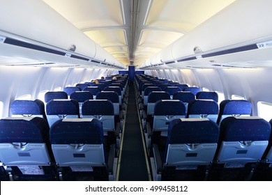 Aircraft Interior With Blue Seats And White Panel