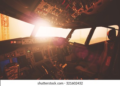 Aircraft Interior, Cockpit View Inside The Airliner. Point Of View From A Pilot Place In A Plane. Sunny Sky Horizon View From An Airplane Front Glass.