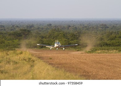 An Aircraft Landing On A Remote Dirt Airstrip Deep In The Botswana Bush Somewhere Between Gabarone And Makgadikgadi.