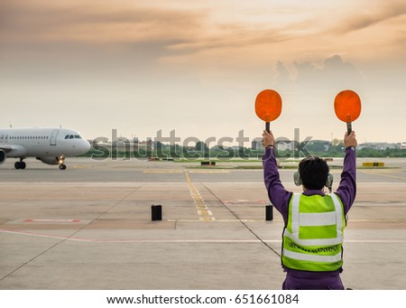 Aircraft maintenance flight engineer show parking sign for captain at airport