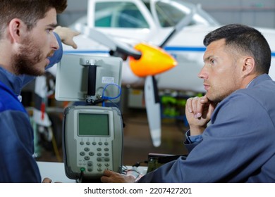 Aircraft Maintenance Mechanic Inspects Plane Chassis