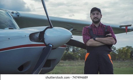 Aircraft Mechanic Standing Satisfied With His Job.