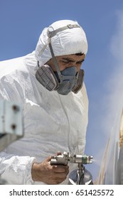 Aircraft Painting And Sandblasting.  Spray Painting, Airplane Wing. Worker In Coverall Using Airbrush. Passenger Aircraft During Maintenance And Painting.