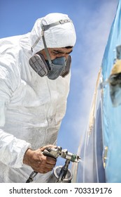 Aircraft Painting And Sandblasting.  Spray Painting, Airplane Wing. Worker In Coverall Using Airbrush. Passenger Aircraft During Maintenance And Painting.