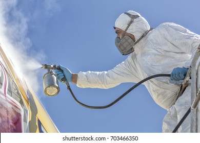 Aircraft Painting And Sandblasting.  Spray Painting, Airplane Wing. Worker In Coverall Using Airbrush. Passenger Aircraft During Maintenance And Painting.