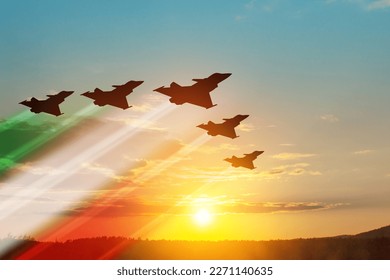 Aircraft silhouettes with flag color trails on background of sunset. Air Force Day. 28 March, Italian Air Force. - Powered by Shutterstock