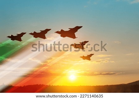 Aircraft silhouettes with flag color trails on background of sunset. Air Force Day. 28 March, Italian Air Force.