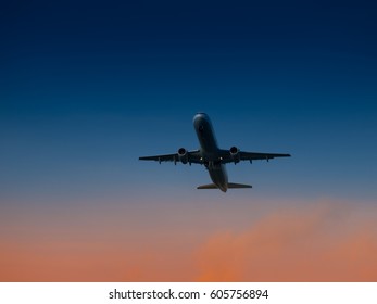 Aircraft Take-off From Airport At Sunset Time. Air Transportation And Overnight Flight Theme.