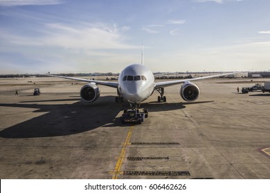 Aircraft Tugging To A Boarding Sleeve By A Pusher Tug