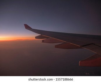 Aircraft wind on the sunrise sky background , Morning sunrise with Wing of an airplane