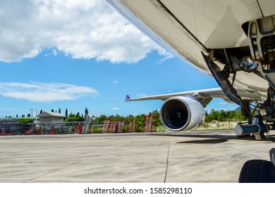 Aircraft(airplane) Parking For Maintenance Before Flight And Blue Sky With Clouds In Background.Aircraft Parking In Front Of Aircraft Hangar For Maintenance.