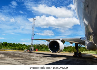 Aircraft(airplane) Parking For Maintenance Before Flight And Blue Sky With Clouds In Background.Aircraft Parking In Front Of Aircraft Hangar For Maintenance.