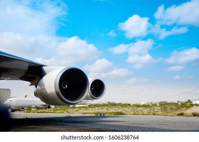 Aircraft(airplane) Parking For Maintenance Before Flight And Blue Sky With Clouds In Background.Aircraft Parking In Front Of Aircraft Hangar For Maintenance.