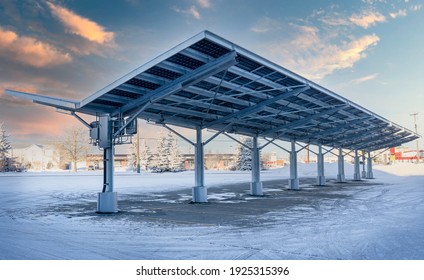 Airdrie Alberta Canada, February 15, 2021: A modern solar carport for public vehicle parking is outfitted with solar panels producing renewable energy.