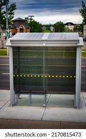 Airdrie Alberta Canada, June 12 2022: Bus Stop Transit Shelter With Solar Panels On The Roof For Sustainable Energy Production.