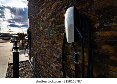 Airdrie Alberta Canada, May 06 2022: Tesla Level 2 Chargers Mounted On A Brick Wall For EV Charging At The Days Inn Suites For Travellers.