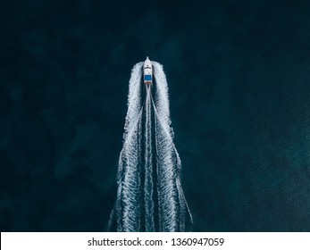 Airial Foto Of A Speed Boat Passing By On A Lake Creating A Beautifull Riiple On The Water