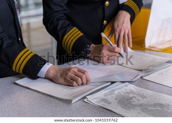 Airline Pilot Reading Flight Document Before Stock Photo (Edit Now ...