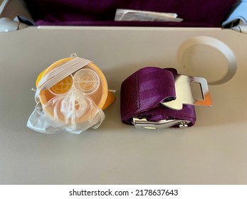 The Airline Safety Demonstration Set On The Tray: Seat Belt And Oxygen Mask