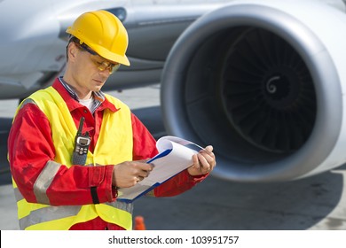 Airline Safety Engineer Going Through A Pre-flight Checklist