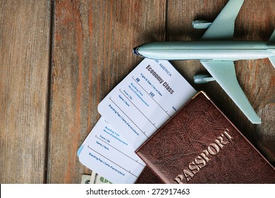 Airline tickets and documents on wooden table, top view