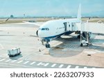 Airplane, airport and runway near terminal and boarding steps for a flight for travel, logistics or commercial transport. Plane, aircraft and airline vehicle outdoors in Cape Town International