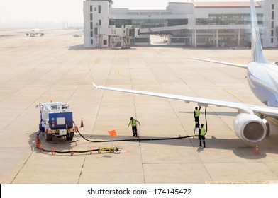 Airplane In Airport Serviced By The Ground Crew