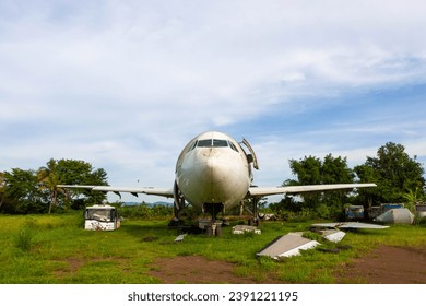 Airplane and airport shuttle bus junk at airplanes graveyard near Chiang Mai in Thailand. - Powered by Shutterstock