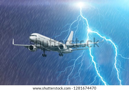 Airplane approach at the airport landing in bad weather storm hurricane rain llightning strike.