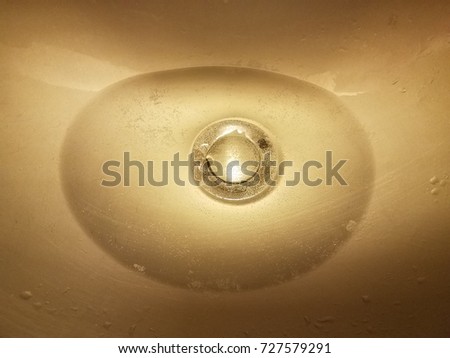 an airplane bathroom sink with water in it