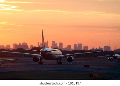 airplane before New York skyline, at departure, at sunset