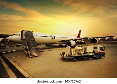 Airplane Is Being Serviced By The Ground Crew.