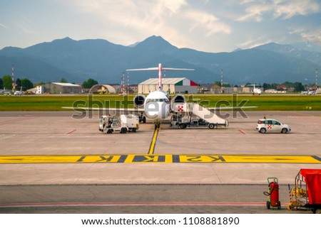 Airplane boarding at the airport in Bergamo Orio Airport. It is one of fastest growing airports in Italy.
