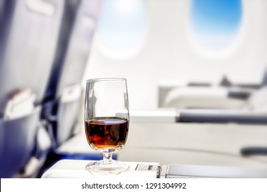 Airplane business glass drink in beautiful style of passenger plane first class cabin with luxury modern executive jet seat and window indoor view air travel design aerial landscape background