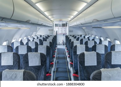 Airplane Cabin And Aisle With Empty Comfortable Seats In Economy Class Inside Of Plane