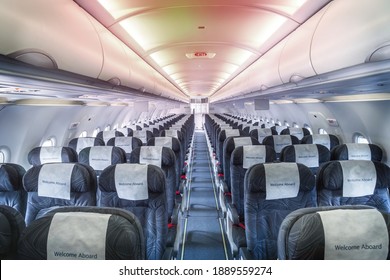 Airplane Cabin And Aisle With Empty Comfortable Seats In Economy Class Inside Of Plane