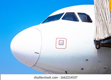 Airplane Cabin Behind, Cockpit The Door, Close-up On A Background Of Blue Sky