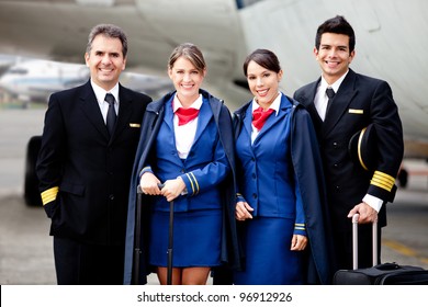 Airplane Cabin Crew Standing At The Airport With Bags