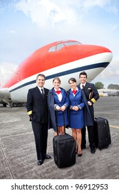 Airplane Cabin Crew Standing At The Airport With Bags