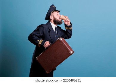 Airplane Captain In Professional Airline Uniform Running Late, Carrying Suitcase, Drinking Coffee To Go. Pilot With Luggage In Airport, Aviator With Baggage Holding Tea Paper Cup, Side View