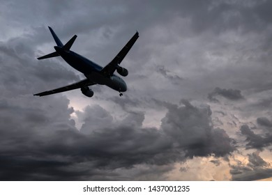 Airplane With Dramatic Sky, Flying At Bad Weather With Dark Clouds