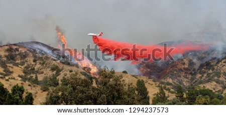 Airplane Drops Fire Retardant on Wildfire