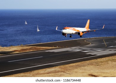 Airplane EasyJet  Airbus Flying To The Airport Runway. The Commercial Jet Aeroplane Started The Landing Gear System For Landing.. Airport Funchal, Madeira, Portugal. Atlantic Ocean. August 12, 2018.