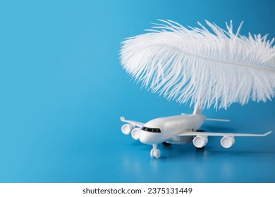 airplane and feather on a blue background, soft landing, easy and comfortable flight