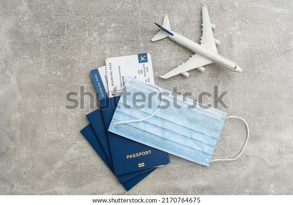 Airplane in flight with a medical mask. Concept\
- observance of safety on the plane. Traveling by air at social\
distance. Compliance with the recommendations of doctors on trips.\
Opening borders.