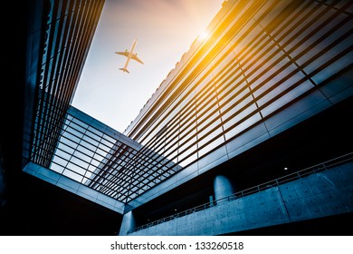 airplane fly above the airport building at shanghai china.
