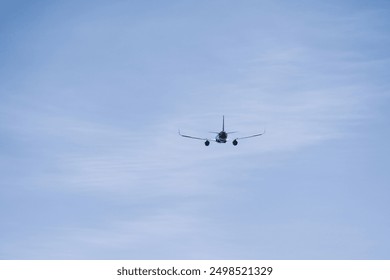 Airplane flying in blue sky, back view. Passenger plane at flight, travel concept - Powered by Shutterstock