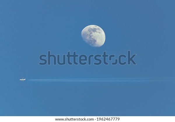 airplane flying close to\
moon