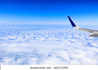 Airplane flying at high altitude and beautiful high-altitude clouds in spring
