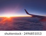 Airplane flying low over snowy mountains and preparing for landing to the airport, view from plane window of wing turbine and skyline